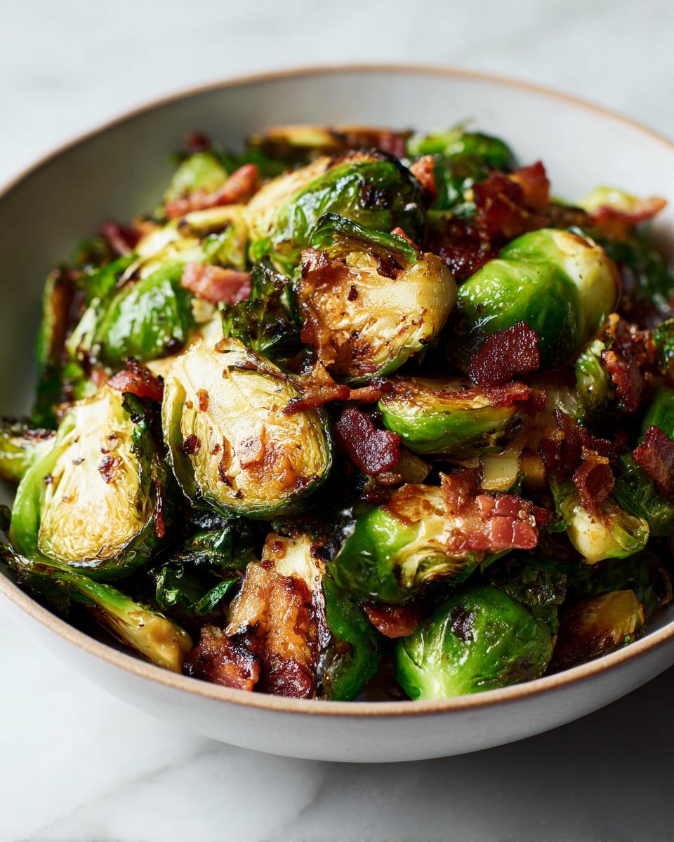 Close-up of Maple Bacon Brussels Sprouts in a bowl, showing crispy sprouts and bacon pieces.