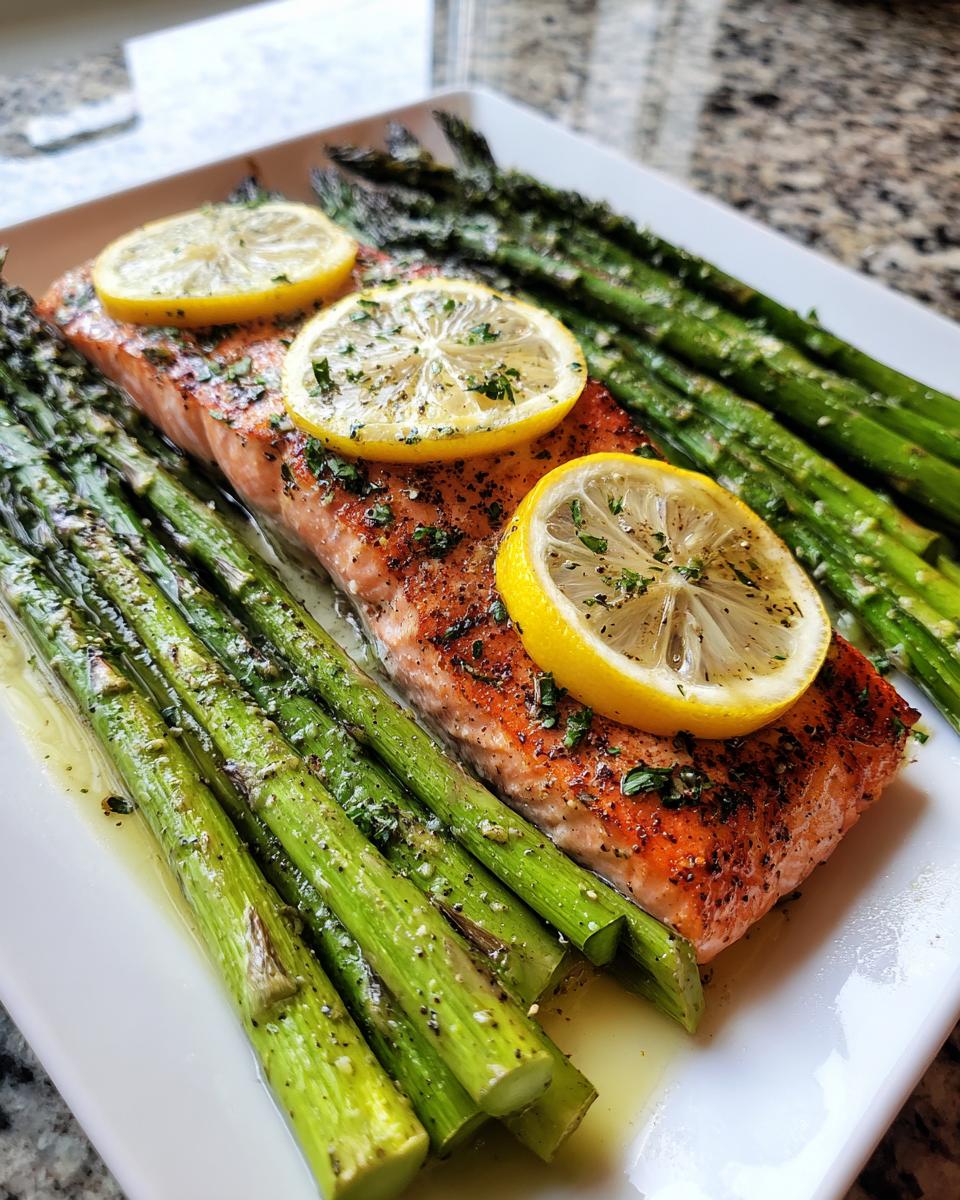 Salmon fillet with asparagus and lemon slices, a delicious and easy low-carb dinner.
