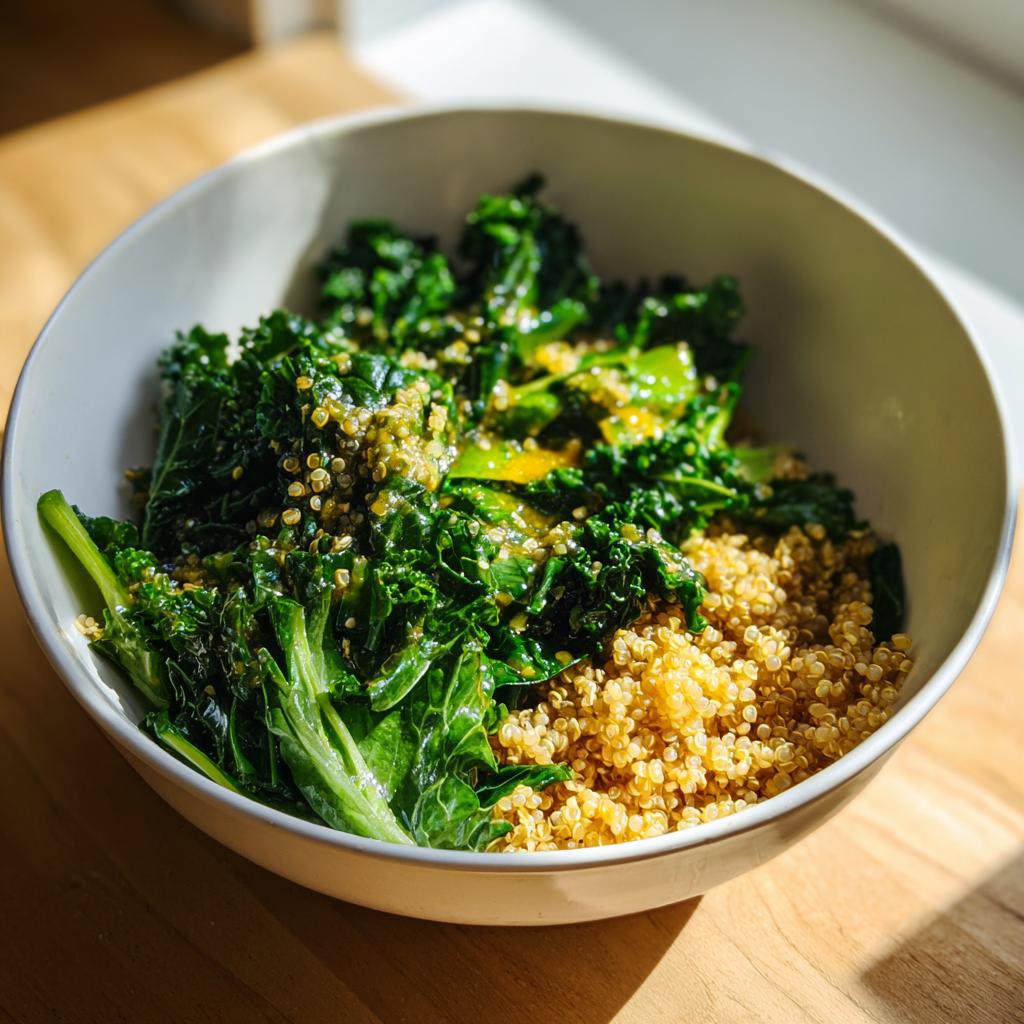 A healthy bowl of Evergreen 2024 quinoa and sautéed kale, drizzled with a light dressing.