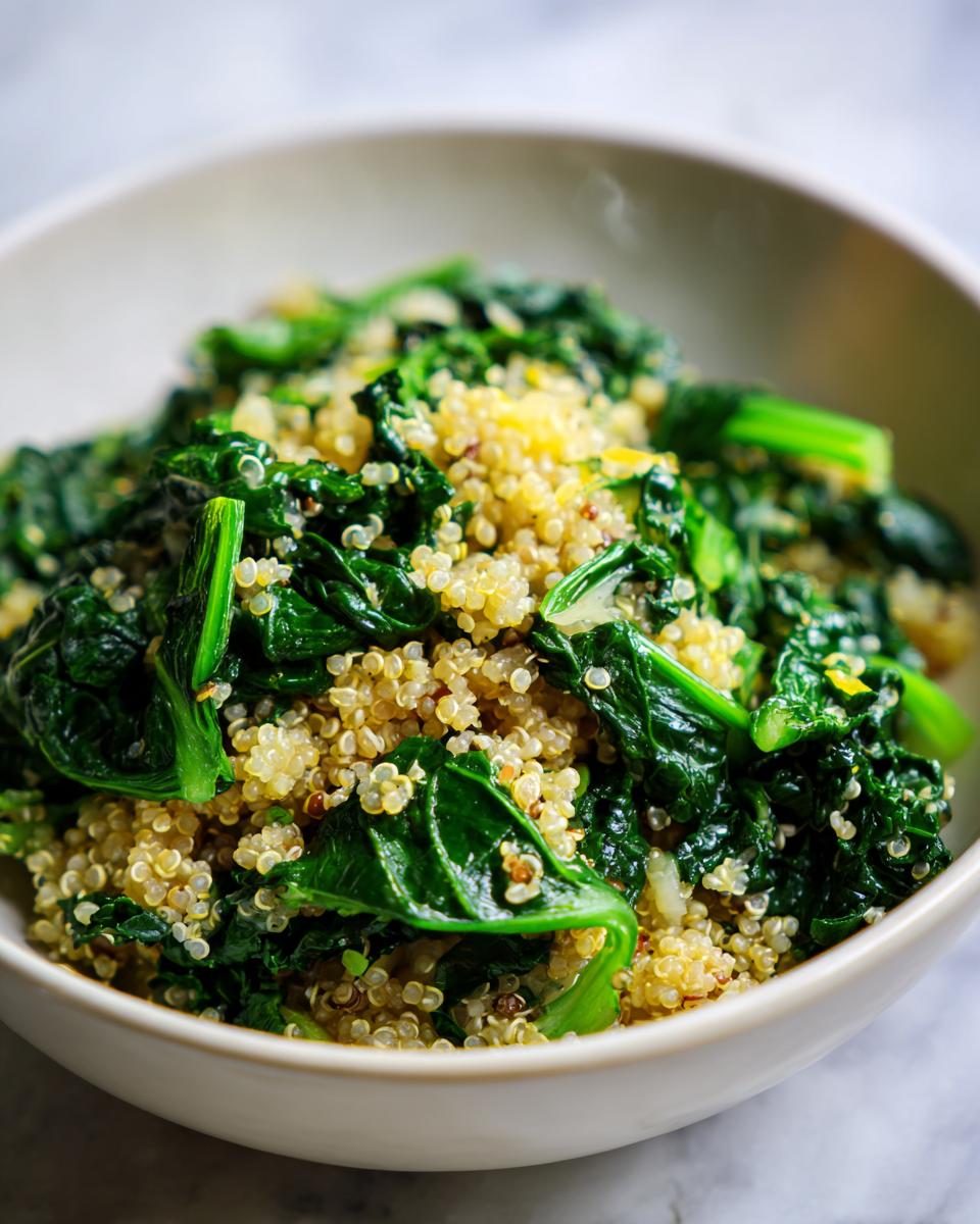 A close-up of a white bowl filled with a healthy Evergreen 2024 recipe of quinoa and wilted spinach.