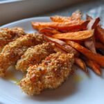 Plate with crispy baked chicken tenders and golden sweet potato fries