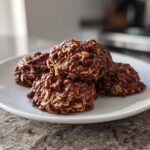 Close-up of chocolate no bake cookie recipes stacked on a white plate.