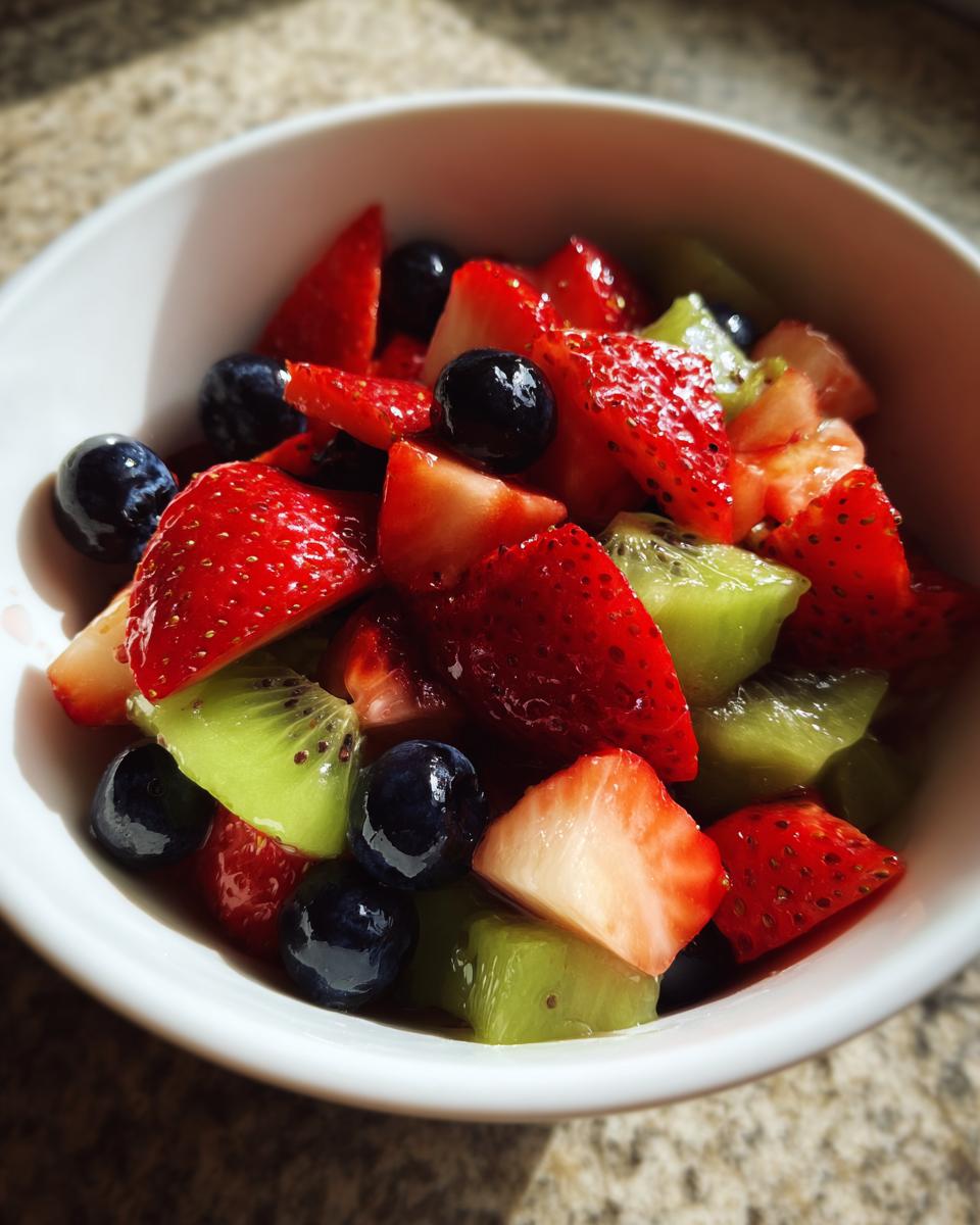 Bowl of fresh strawberries, blueberries, and kiwi for fruit dessert recipes