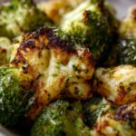 Close-up of garlic parmesan broccoli, a flavorful vegetable side dish recipe with herbs and seasoning.