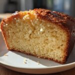 Close-up of a moist slice of pound cake on a white plate, perfect for simple baking recipes